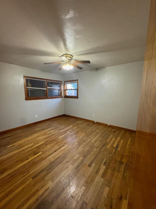 empty room featuring wood-type flooring and a textured ceiling