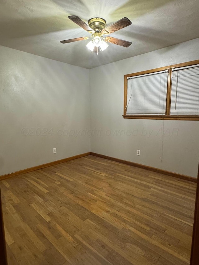 spare room featuring hardwood / wood-style flooring and ceiling fan