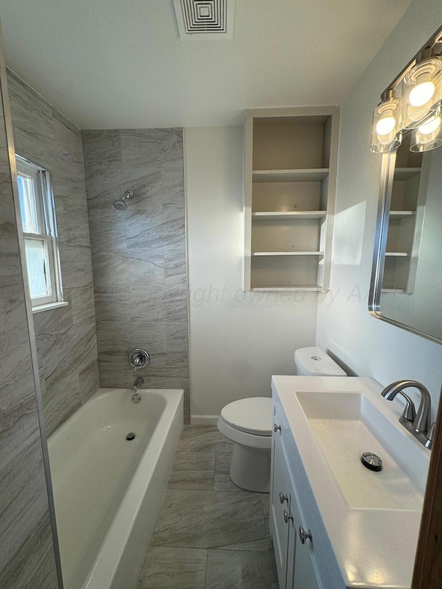 full bathroom with vanity, toilet, and tiled shower / bath