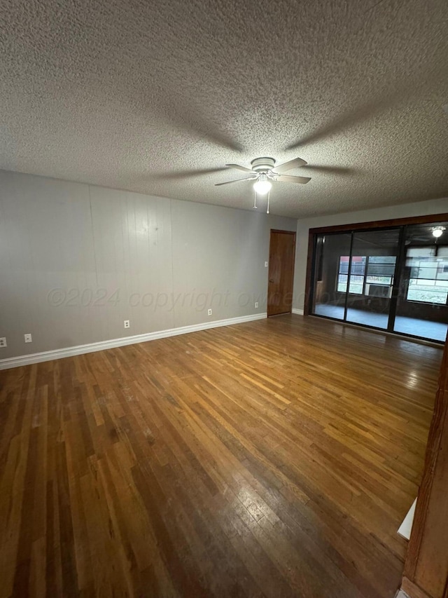 spare room with ceiling fan, a textured ceiling, and hardwood / wood-style flooring