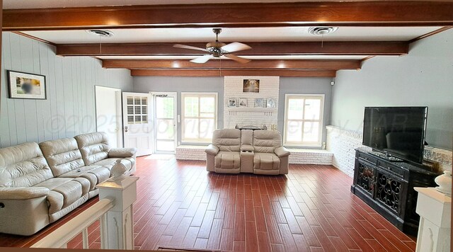 907 Cherry Ave, Dalhart, TX 79022 - living area with ceiling fan, beamed ceiling, dark wood finished floors, and a fireplace