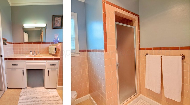 907 Cherry Ave, Dalhart, TX 79022 - full bathroom with tile walls, tile patterned floors, a stall shower, vanity, and toilet