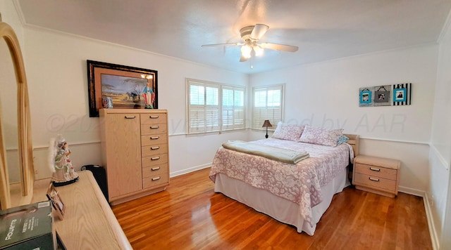 907 Cherry Ave, Dalhart, TX 79022 - bedroom with light wood-type flooring, ornamental molding, baseboards, and ceiling fan
