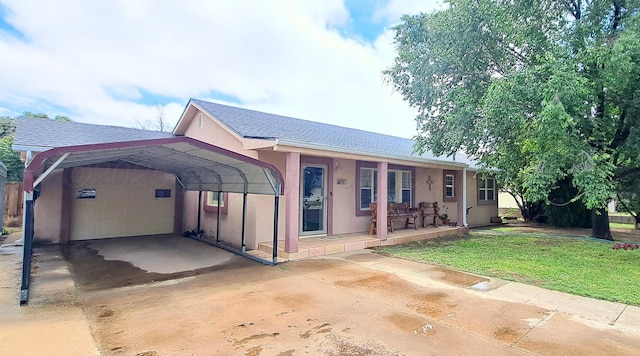 907 Cherry Ave, Dalhart, TX 79022 - view of front facade featuring concrete driveway, a porch, stucco siding, a front yard, and roof with shingles