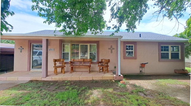 907 Cherry Ave, Dalhart, TX 79022 - view of front of house with stucco siding and a porch