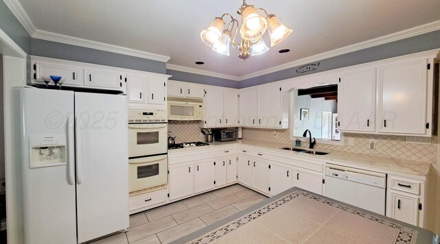 907 Cherry Ave, Dalhart, TX 79022 - kitchen featuring white appliances, a sink, a chandelier, backsplash, and white cabinetry