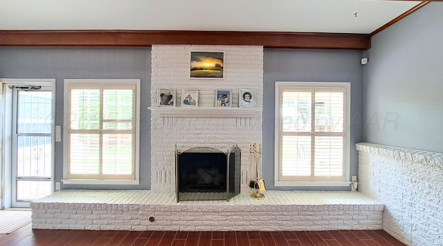 907 Cherry Ave, Dalhart, TX 79022 - unfurnished living room featuring wood finished floors, a fireplace, and plenty of natural light