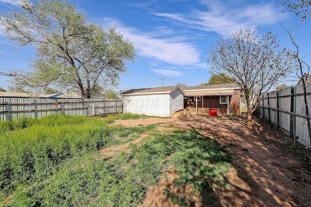 view of yard featuring an outbuilding and a fenced backyard