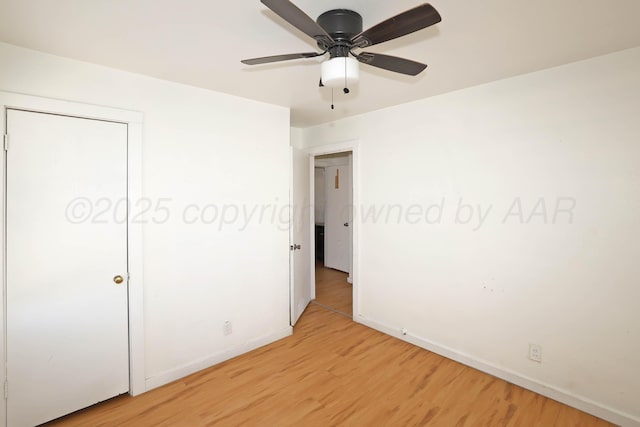 unfurnished bedroom with baseboards, light wood-type flooring, and ceiling fan