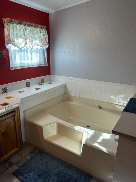 bathroom featuring a bath and vanity