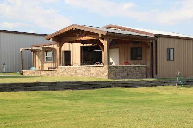 rear view of property with a lawn