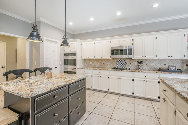 7826 Tarrytown Ave, Amarillo, TX 79121 - kitchen featuring backsplash, white cabinets, hanging light fixtures, and stainless steel appliances