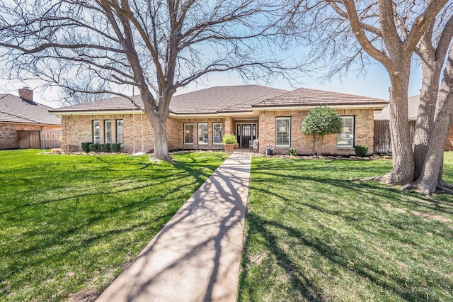 7826 Tarrytown Ave, Amarillo, TX 79121 - ranch-style house with fence, a front yard, and brick siding
