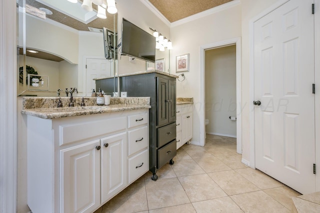 7826 Tarrytown Ave, Amarillo, TX 79121 - bathroom with crown molding, tile patterned flooring, toilet, and vanity
