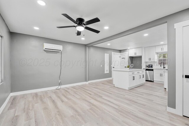 1108 N Taylor St, Amarillo, TX 79107 - unfurnished living room with a wall unit AC, light wood-type flooring, recessed lighting, and a ceiling fan