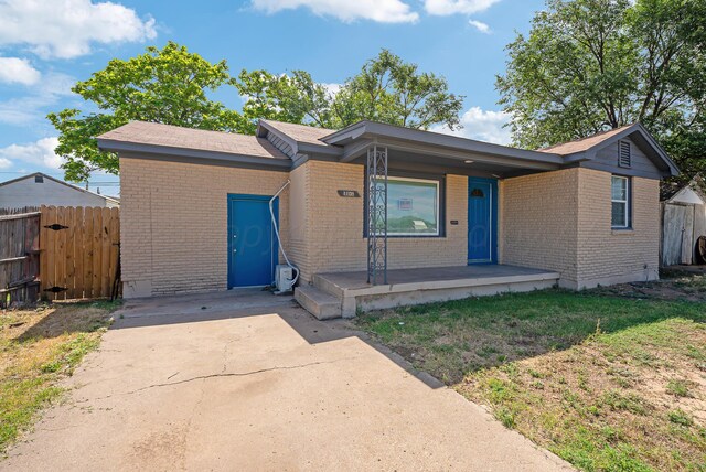 1108 N Taylor St, Amarillo, TX 79107 - ranch-style house with brick siding, covered porch, and driveway