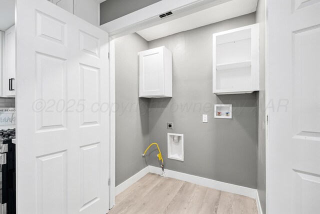 1108 N Taylor St, Amarillo, TX 79107 - laundry area with washer hookup, light wood finished floors, hookup for a gas dryer, hookup for an electric dryer, and cabinet space