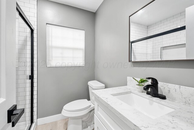 1108 N Taylor St, Amarillo, TX 79107 - full bathroom with a shower stall, vanity, and wood finished floors