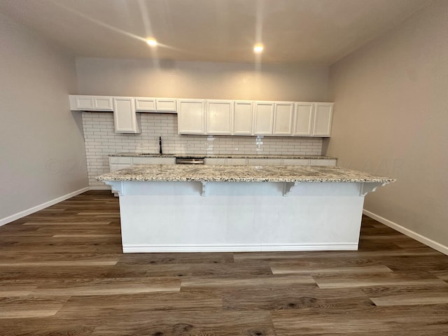 kitchen featuring white cabinetry, dark wood-type flooring, and a kitchen island