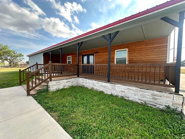 view of home's exterior with covered porch and a yard