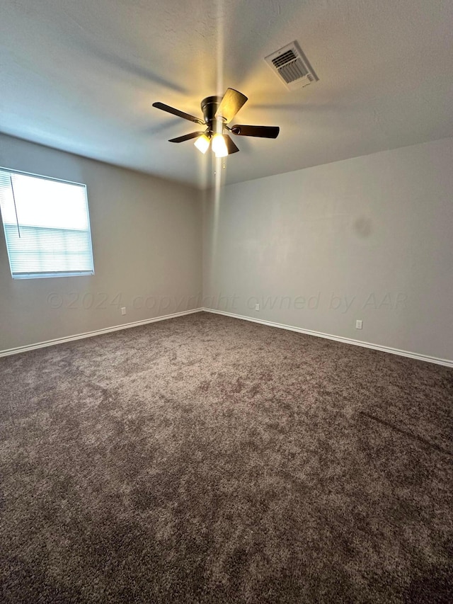 spare room featuring ceiling fan and carpet floors