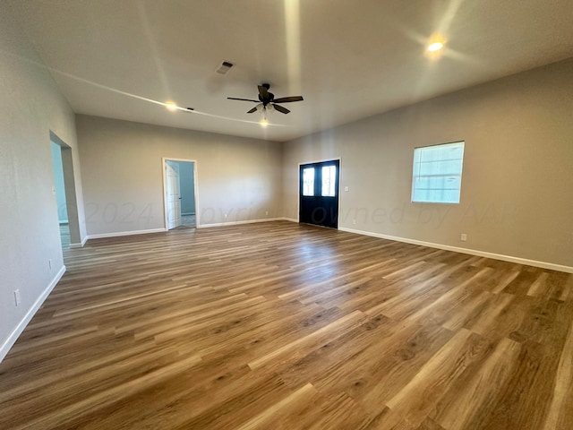 unfurnished living room featuring hardwood / wood-style flooring and ceiling fan