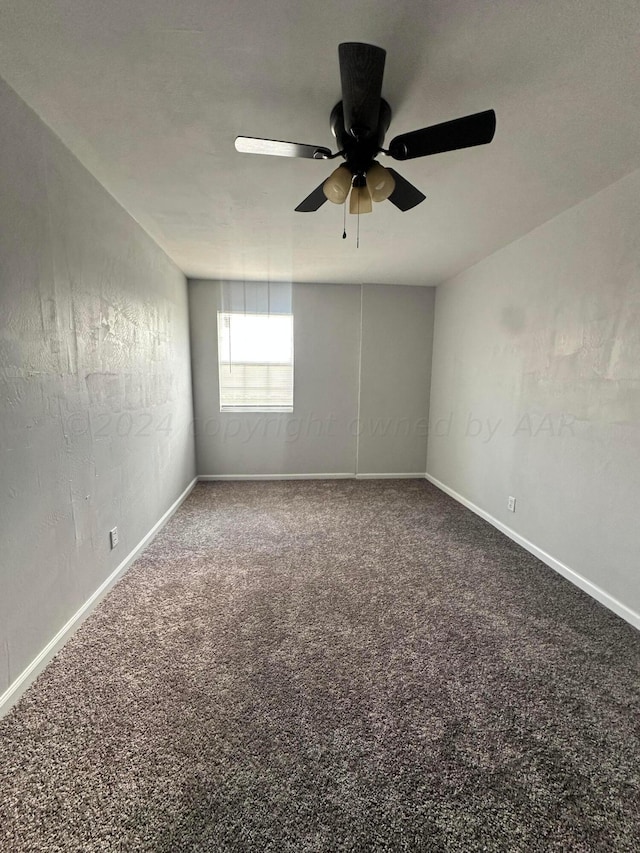 unfurnished room with ceiling fan and carpet