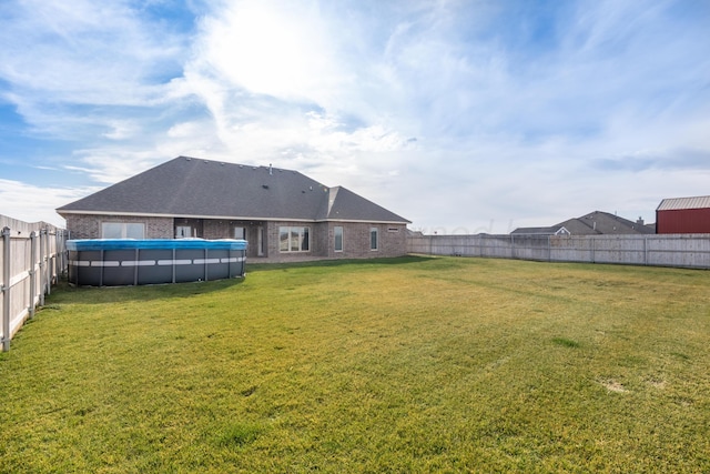 view of yard with a fenced in pool