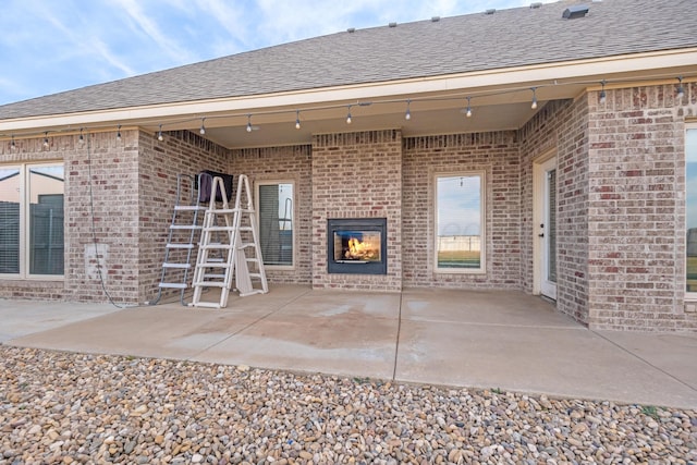 view of patio / terrace with an outdoor brick fireplace