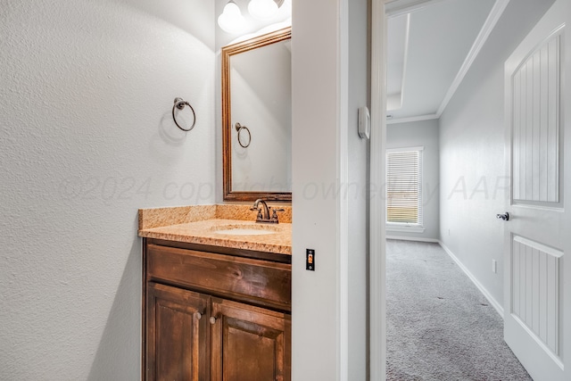 bathroom with crown molding and vanity