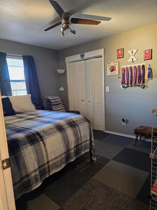 bedroom with carpet, ceiling fan, and a closet