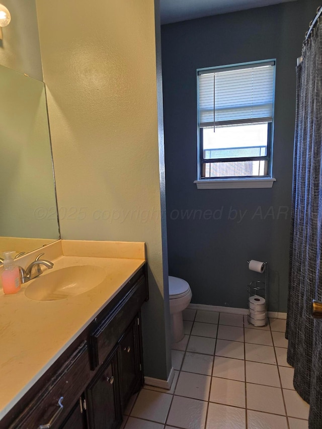 bathroom featuring vanity, toilet, and tile patterned flooring