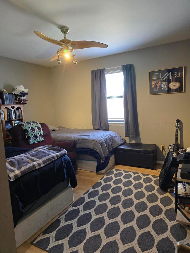 bedroom with ceiling fan and light wood-type flooring