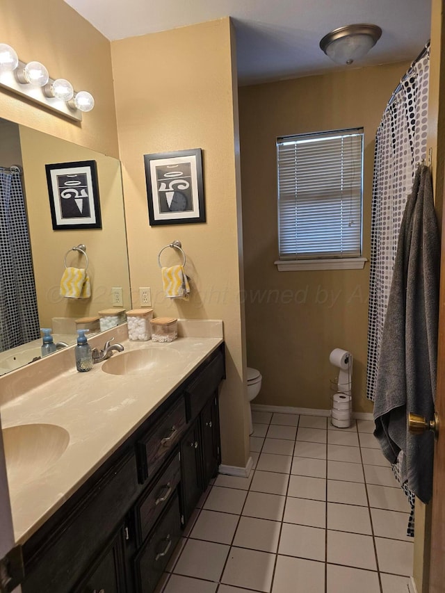 bathroom featuring tile patterned flooring, vanity, and toilet