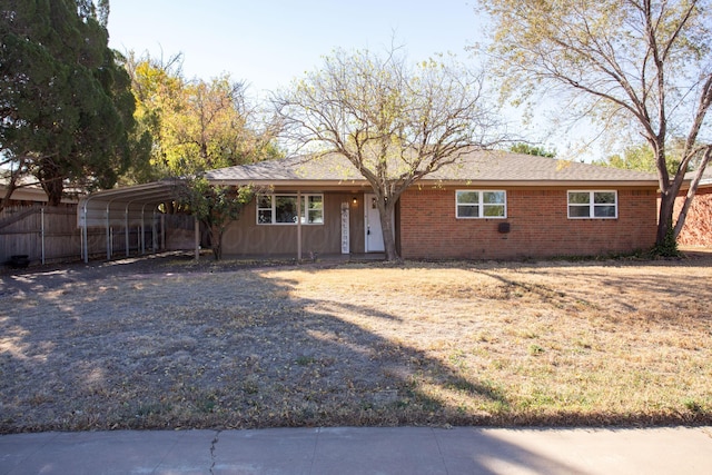 ranch-style house featuring a carport and a front lawn