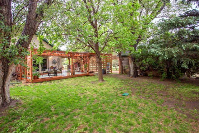 803 N Locust St, Wildorado, TX 79098 - view of green lawn with a pergola and a deck