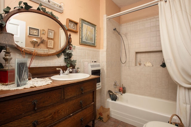 803 N Locust St, Wildorado, TX 79098 - bathroom featuring shower / bath combination with curtain, tile patterned flooring, heating unit, vanity, and a wainscoted wall