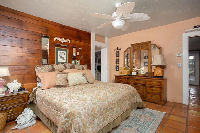 803 N Locust St, Wildorado, TX 79098 - bedroom with wood walls, light tile patterned flooring, and ceiling fan