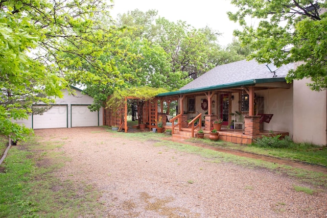 803 N Locust St, Wildorado, TX 79098 - view of front of property with a porch, an outdoor structure, a garage, driveway, and a shingled roof