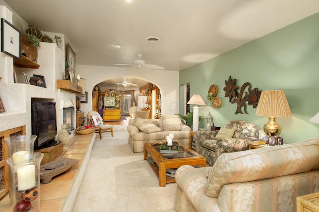 803 N Locust St, Wildorado, TX 79098 - living room with arched walkways, a ceiling fan, light colored carpet, and a glass covered fireplace