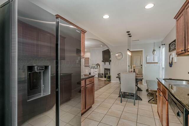 8508 Littlerock Dr, Amarillo, TX 79118 - kitchen featuring dishwasher, stainless steel fridge, arched walkways, a sink, and light tile patterned flooring