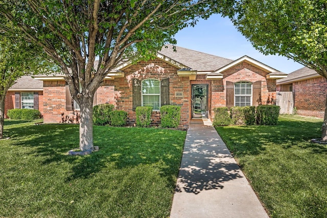 8508 Littlerock Dr, Amarillo, TX 79118 - view of front facade with brick siding, a front lawn, and a shingled roof