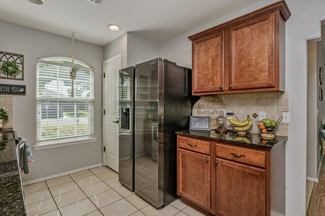 8508 Littlerock Dr, Amarillo, TX 79118 - kitchen with stainless steel fridge with ice dispenser, healthy amount of natural light, dark stone counters, decorative backsplash, and recessed lighting