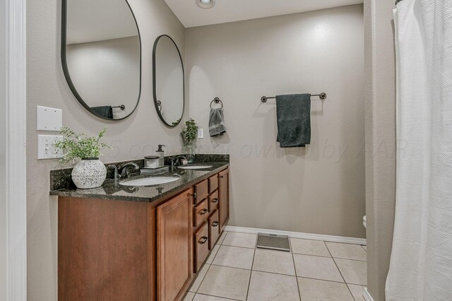 8508 Littlerock Dr, Amarillo, TX 79118 - full bathroom featuring double vanity, tile patterned flooring, and baseboards