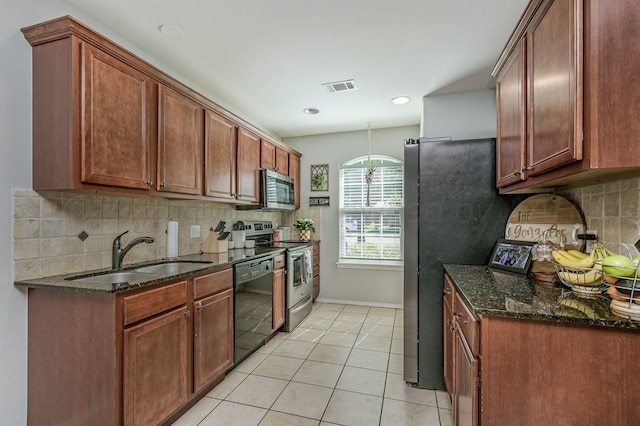 8508 Littlerock Dr, Amarillo, TX 79118 - kitchen with appliances with stainless steel finishes, a sink, light tile patterned floors, and decorative backsplash