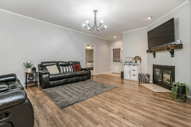 8508 Littlerock Dr, Amarillo, TX 79118 - living room with a chandelier, ornamental molding, wood finished floors, a tiled fireplace, and baseboards