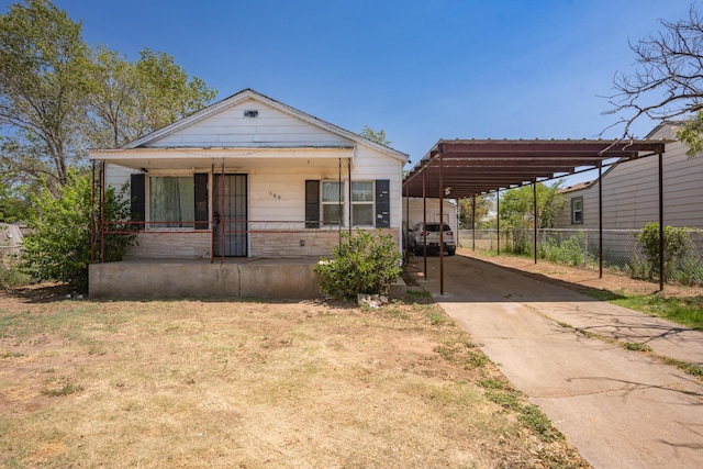 view of front of property featuring a carport and a porch