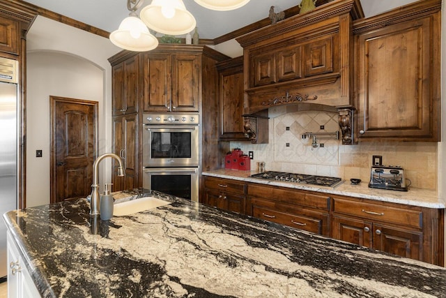 2501 Mackenzie Trl, Amarillo, TX 79124 - kitchen with light stone countertops, custom exhaust hood, a sink, appliances with stainless steel finishes, and backsplash