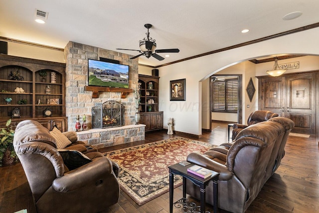 2501 Mackenzie Trl, Amarillo, TX 79124 - living room with visible vents, baseboards, ceiling fan, hardwood / wood-style floors, and arched walkways