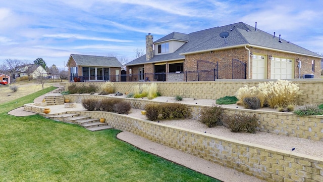 2501 Mackenzie Trl, Amarillo, TX 79124 - rear view of house featuring stairs, a yard, roof with shingles, brick siding, and a chimney
